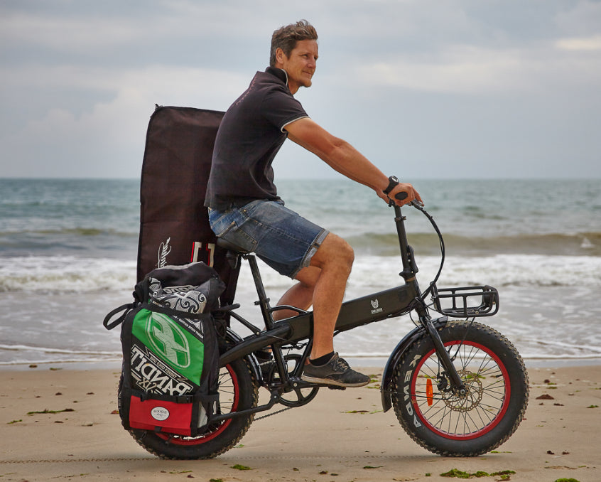 Vélo fat bike transportant une aile et une planche de kite grâce aux sacoches Bakkiee sur la plage